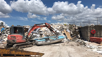 A boat being picked up by an excavator