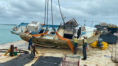 A damaged boat being dismantled