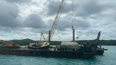 A boat on a barge being taken for disposal