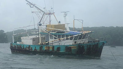 A damaged boat floating on the water